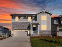 Two-story house with stone accents and a landscaped yard at 23927 E Atlantic Pl, Aurora, CO 80018