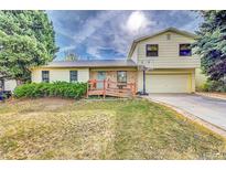Ranch style home with attached garage and basketball hoop at 1550 S Telluride St, Aurora, CO 80017