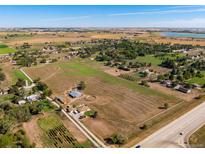 Aerial view of a ranch house on a large lot with outbuildings at 1637 S Us Highway 287, Berthoud, CO 80513