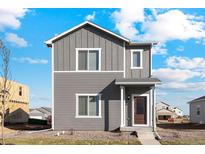 Two-story gray townhome with front yard at 2971 Pershing St, Strasburg, CO 80136