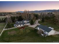 Aerial view of a two-story home with detached garage and landscaping at 9362 Tollgate Dr, Longmont, CO 80503