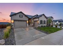 Two-story house with attached garage and landscaped yard at 6940 Petunia Pl, Castle Rock, CO 80108