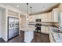 Spacious kitchen with granite countertops and stainless steel appliances at 10562 Racine St, Commerce City, CO 80022