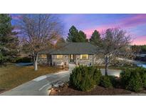 Brick ranch home with landscaped yard and large driveway at 6690 S Sheridan Blvd, Littleton, CO 80123
