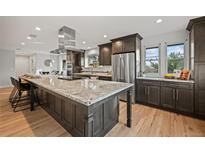 Spacious kitchen with stainless steel appliances and granite island at 6690 S Sheridan Blvd, Littleton, CO 80123