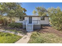 Newly renovated ranch home with gray deck and walkway at 2635 S Josephine St, Denver, CO 80210