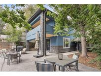 Modern patio with seating area and surrounding trees at 2143 S Downing St, Denver, CO 80210
