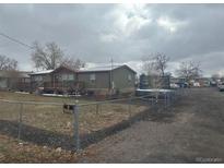 Ranch-style home with a large yard and detached garage at 3440 W 66Th Ave, Denver, CO 80221