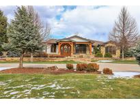 Stunning two-story home with stone accents and a welcoming front porch at 5230 Bow Mar Dr, Littleton, CO 80123