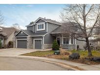 Two-story house with gray siding, three-car garage, and landscaping at 1366 Teton Pt, Lafayette, CO 80026