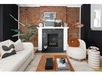 Living room fireplace with exposed brick and modern decor at 1473 Yates St, Denver, CO 80204