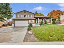 Two-story house with a large yard and attached garage at 9352 W Walden Ave, Littleton, CO 80128