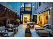 Backyard patio with fire pit, seating area, and kitchen access at 355 Clayton St, Denver, CO 80206