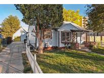 Charming one-story home with front yard and white picket fence at 1340 Xanthia St, Denver, CO 80220