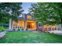 Two-story home with landscaped yard, brick exterior, and attached garage at 1647 Prairie Falcon Ln, Broomfield, CO 80020