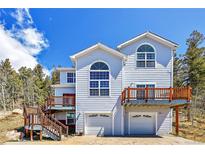 Two-story home with double garage and deck at 11770 Leavenworth Dr, Conifer, CO 80433