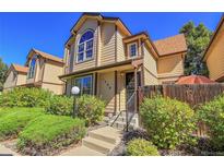 Tan two-story townhome with landscaping and steps at 1736 S Pagosa Way, Aurora, CO 80017