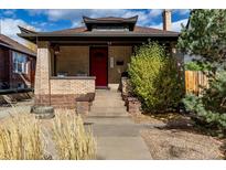 Charming brick house with a red door and landscaping at 3151 W Denver Pl, Denver, CO 80211