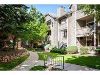 Exterior view of the condo building with landscaping and walkways at 8378 S Upham Way # B301, Littleton, CO 80128