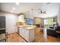 Open kitchen features granite counters and flows into living room at 8378 S Upham Way # B301, Littleton, CO 80128