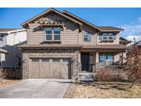 Inviting two-story home with a charming front porch and attached garage at 7844 S Elk St, Aurora, CO 80016