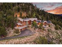 Luxury home nestled in the mountains with a stunning sunset view at 3864 Valley Dr, Evergreen, CO 80439