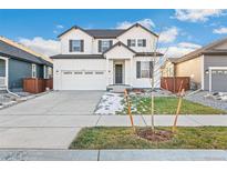 Charming two-story home with white siding, black trim, and a welcoming front porch at 1562 Farmstead St, Brighton, CO 80601