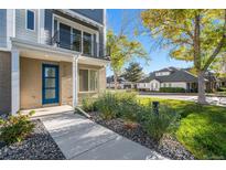 Modern townhome with blue door and landscaping at 888 S Valentia St # 104, Denver, CO 80247