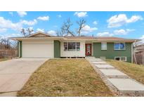 Green brick ranch house with updated landscaping and walkway at 6926 E Dickenson Pl, Denver, CO 80224