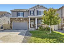 Two story home with gray siding, stone accents and landscaped lawn at 6808 Morrison Dr, Frederick, CO 80530