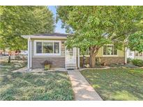 Charming ranch house with stone accents and landscaping at 1891 S Monroe St, Denver, CO 80210