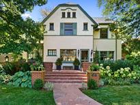 Two-story house with a charming front porch and landscaping at 141 N Gilpin St, Denver, CO 80218