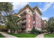 Brick building exterior with balconies and landscaping at 1699 N Downing St # 302, Denver, CO 80218