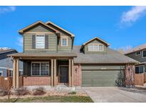 Two-story house with a brick and siding exterior, attached garage, and covered porch at 4050 S Odessa St, Aurora, CO 80013