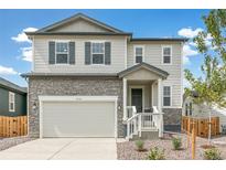 Two-story house with stone accents and a two-car garage at 13332 E 110Th Way, Commerce City, CO 80022
