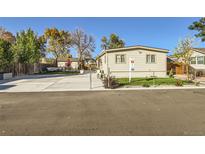 Charming single-wide mobile home with a spacious yard at 109 Wooster Dr, Firestone, CO 80520