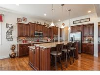 Gourmet kitchen with granite countertops and stainless steel appliances at 1075 Whitekirk Pl, Castle Rock, CO 80104