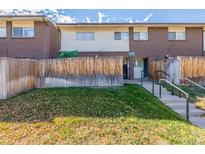 Front view of townhouse with steps and wooden fence at 8051 Wolff St # C, Westminster, CO 80031