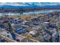 Aerial showing property, lake, and distant city skyline at 2031 Meade St, Denver, CO 80211