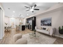 Open living room with a comfy sofa and a modern coffee table at 23630 E 5Th Pl, Aurora, CO 80018