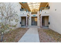 Exterior view of building showing walkway and entrance at 8673 E Dry Creek Rd # 1022, Englewood, CO 80112