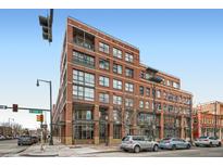 Brick building with multiple windows and commercial spaces on the ground floor at 1499 Blake St # 1A & 1B, Denver, CO 80202