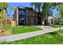 Modern two-story home with a landscaped front yard and a paved walkway at 3916 N Raleigh St, Denver, CO 80212