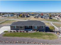 Aerial view of house, showcasing its ranch style and neighborhood at 12535 Valentia St, Brighton, CO 80602