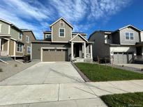 Two-story house with attached garage and landscaping at 5571 Wisteria Avenue, Firestone, CO 80107