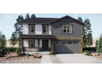 Two-story home with gray and white siding, stone accents, and a two-car garage at 22077 E 39Th Ave, Aurora, CO 80019