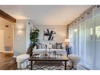 Cozy living room with neutral decor and sliding glass doors at 40 S Boulder Cir # 4014, Boulder, CO 80303