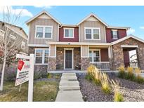 Two-story home with stone and siding exterior, front porch, and landscaping at 6251 N Malaya St, Aurora, CO 80019