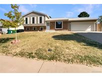 Ranch-style home with a brick and siding exterior and a two-car garage at 19237 E Kansas Dr, Aurora, CO 80017