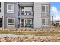 Exterior view of a modern two-story condo with a balcony and holiday decorations at 16841 Askins Loop # 101, Parker, CO 80134